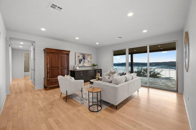 19000 Silver Maple Dr, Lago Vista, TX 78645 - living area featuring light wood-style flooring, recessed lighting, baseboards, and a water view