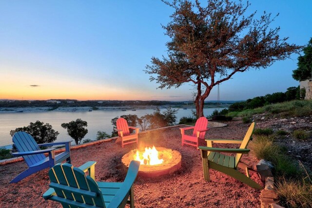 19000 Silver Maple Dr, Lago Vista, TX 78645 - patio terrace at dusk featuring an outdoor fire pit and a water view