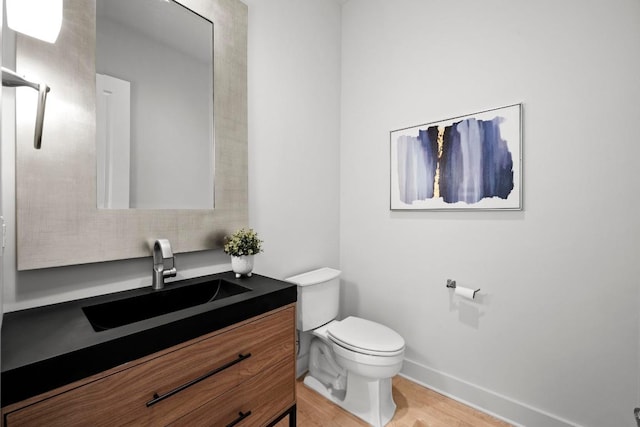 19000 Silver Maple Dr, Lago Vista, TX 78645 - bathroom with toilet, wood finished floors, vanity, and baseboards