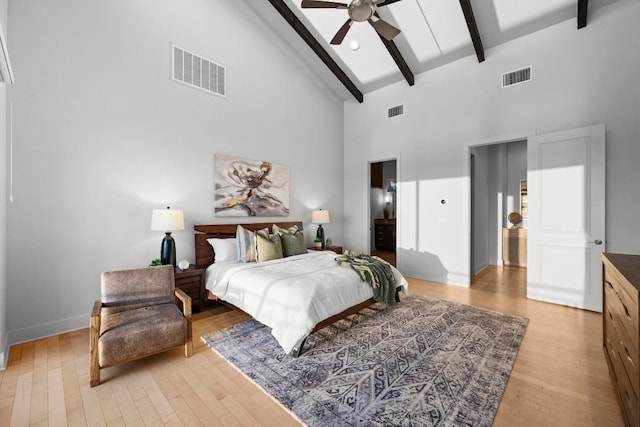 19000 Silver Maple Dr, Lago Vista, TX 78645 - bedroom featuring high vaulted ceiling, light wood-style floors, beamed ceiling, baseboards, and ceiling fan