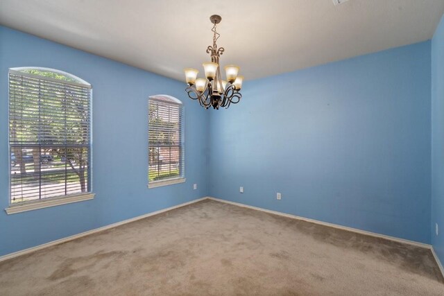 13617 Sun Dapple Ct, Manor, TX 78653 - carpeted spare room featuring a chandelier, plenty of natural light, and baseboards