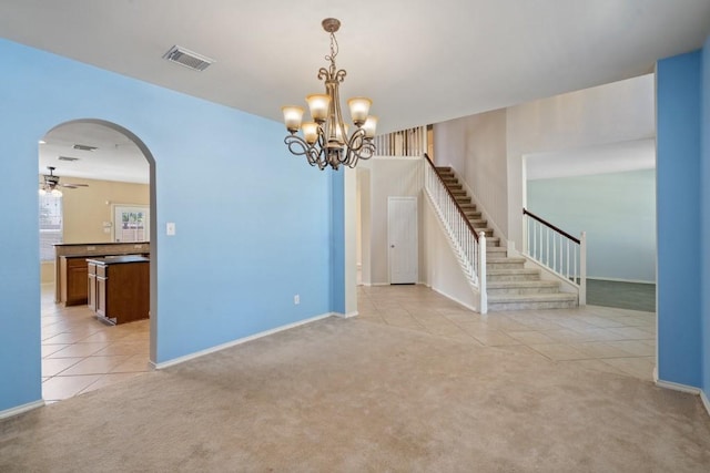13617 Sun Dapple Ct, Manor, TX 78653 - spare room featuring light tile patterned floors, light colored carpet, arched walkways, ceiling fan, and baseboards