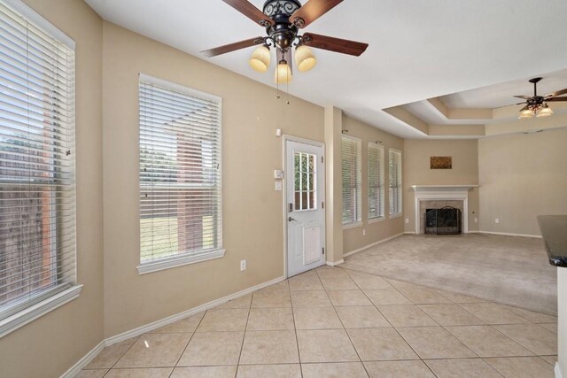 13617 Sun Dapple Ct, Manor, TX 78653 - unfurnished living room with a ceiling fan, plenty of natural light, baseboards, and a fireplace