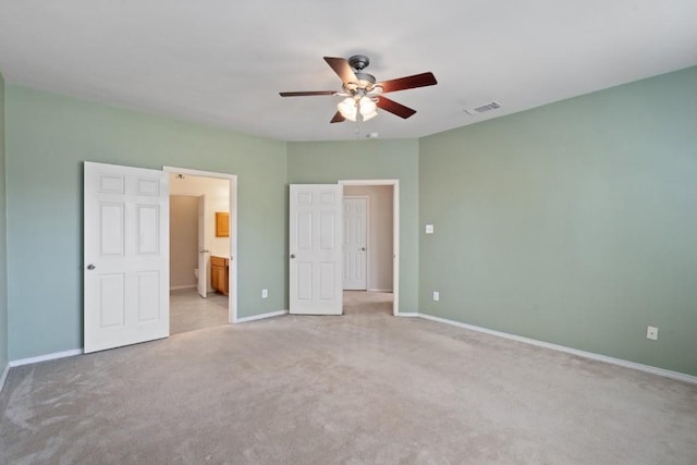13617 Sun Dapple Ct, Manor, TX 78653 - unfurnished bedroom with light colored carpet, baseboards, connected bathroom, and ceiling fan