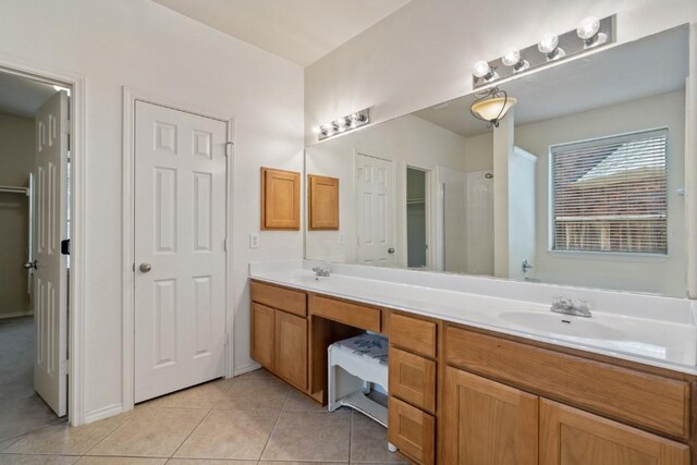 13617 Sun Dapple Ct, Manor, TX 78653 - full bathroom with double vanity, tile patterned flooring, a closet, and a shower