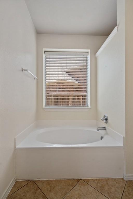 13617 Sun Dapple Ct, Manor, TX 78653 - bathroom featuring tile patterned flooring and a bath