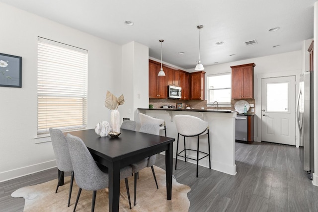 1601 Miriam Ave Unit 210, Austin, TX 78702 - dining area with wood finished floors, baseboards, and recessed lighting