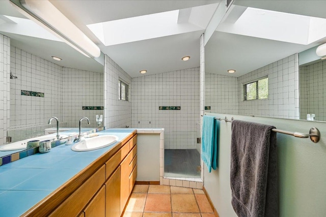 3403 Spanish Oak Dr, Austin, TX 78731 - bathroom with tile walls, vanity, a stall shower, a skylight, and tile patterned floors