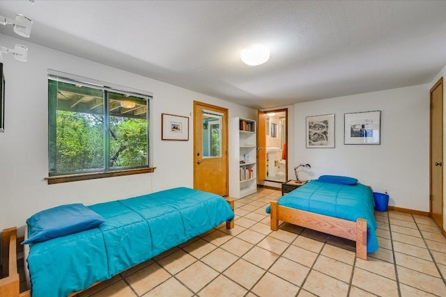 3403 Spanish Oak Dr, Austin, TX 78731 - bedroom featuring light tile patterned floors, baseboards, and ensuite bathroom