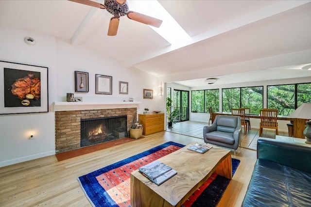 3403 Spanish Oak Dr, Austin, TX 78731 - living room with wood finished floors, a brick fireplace, baseboards, and a ceiling fan