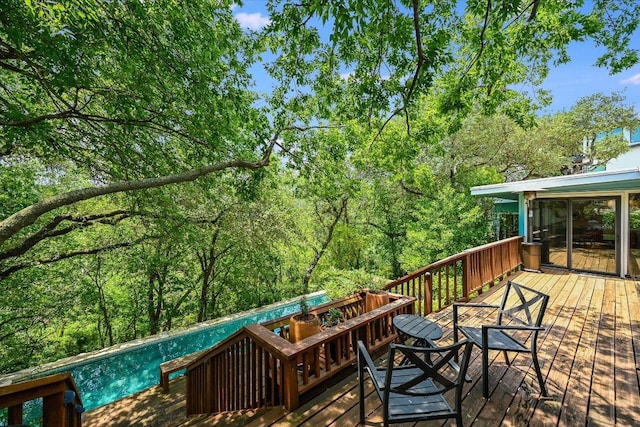 3403 Spanish Oak Dr, Austin, TX 78731 - deck with an outdoor pool and a wooded view