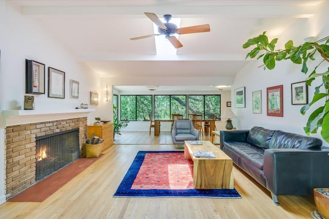 3403 Spanish Oak Dr, Austin, TX 78731 - living room featuring wood finished floors, a brick fireplace, a ceiling fan, and lofted ceiling