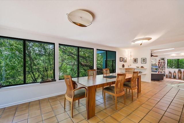 3403 Spanish Oak Dr, Austin, TX 78731 - dining room with light tile patterned floors, ceiling fan, and baseboards