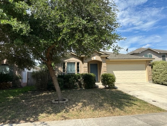221 Roadrunner Ave, New Braunfels, TX 78130 - view of front of property featuring an attached garage, driveway, brick siding, and a front yard