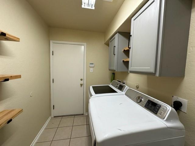 221 Roadrunner Ave, New Braunfels, TX 78130 - washroom with cabinet space, independent washer and dryer, light tile patterned floors, and baseboards