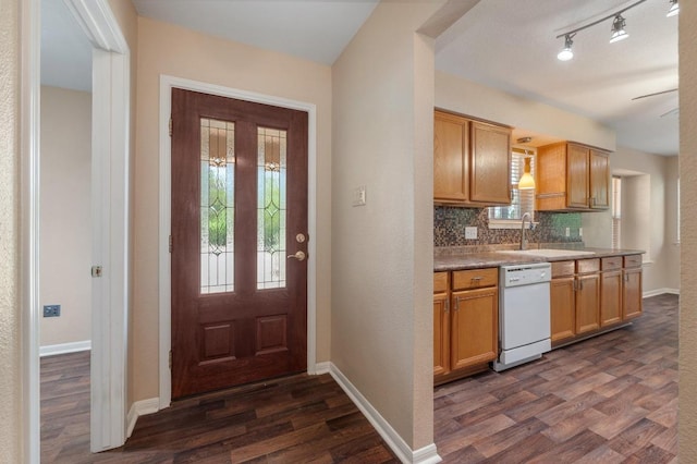 14101 Washoe Cir, Austin, TX 78734 - kitchen featuring white dishwasher, a sink, dark wood-style floors, backsplash, and baseboards