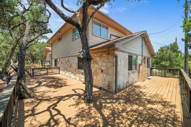 14101 Washoe Cir, Austin, TX 78734 - view of property exterior featuring stone siding and a deck