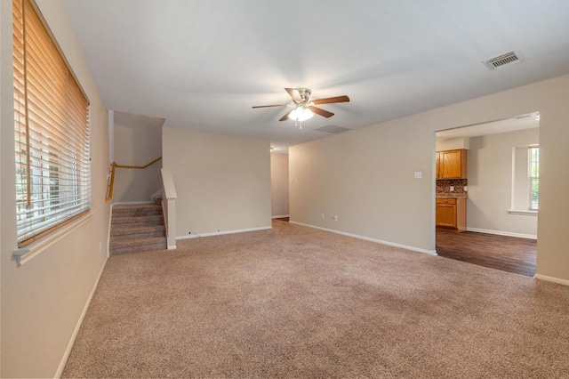 14101 Washoe Cir, Austin, TX 78734 - unfurnished room with carpet flooring, a ceiling fan, stairs, and baseboards