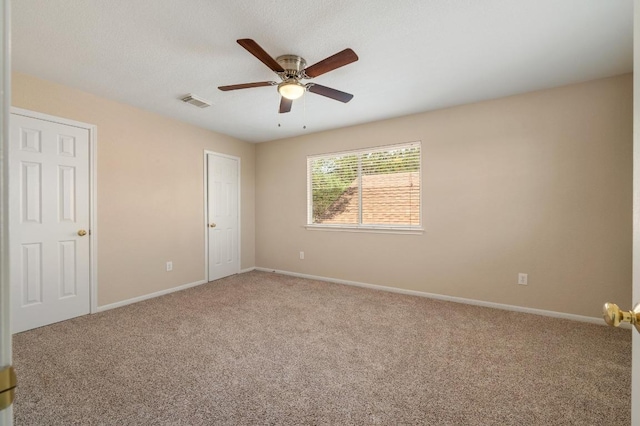 14101 Washoe Cir, Austin, TX 78734 - unfurnished bedroom featuring carpet, baseboards, and a ceiling fan
