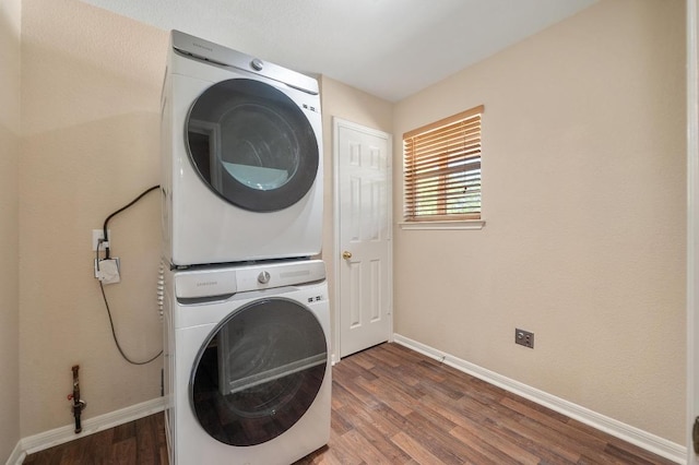 14101 Washoe Cir, Austin, TX 78734 - washroom featuring stacked washer / drying machine, wood finished floors, and baseboards