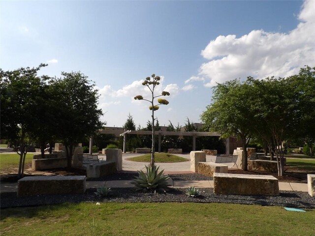 3097 Blantyre Bnd, Round Rock, TX 78664 - view of property's community featuring a lawn, a patio area, and a pergola