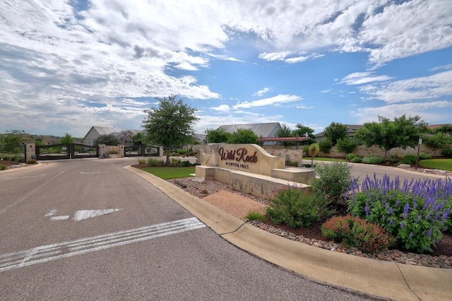 2613 Ibaza Bnd Unit 58, Leander, TX 78641 - community / neighborhood sign featuring uncovered parking and a gate