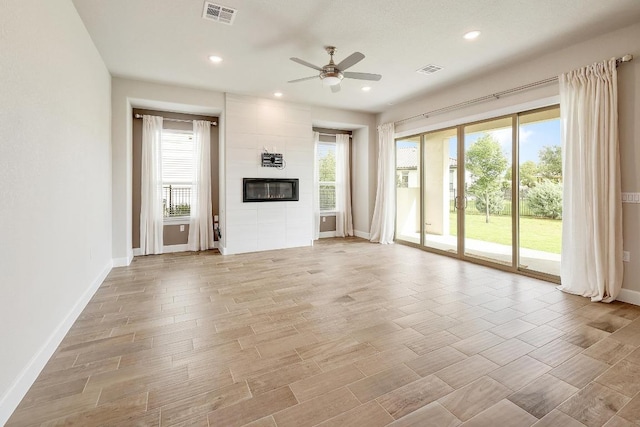 2613 Ibaza Bnd Unit 58, Leander, TX 78641 - unfurnished living room featuring ceiling fan, plenty of natural light, baseboards, a fireplace, and recessed lighting