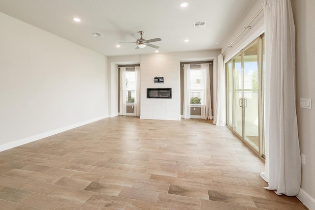 2613 Ibaza Bnd Unit 58, Leander, TX 78641 - unfurnished living room featuring ceiling fan, recessed lighting, baseboards, and a tiled fireplace