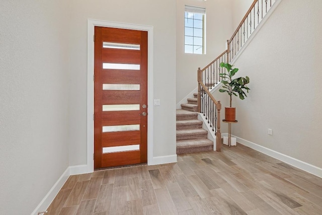 2613 Ibaza Bnd Unit 58, Leander, TX 78641 - entrance foyer with light wood-type flooring, stairs, and baseboards