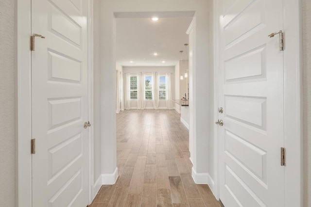 2613 Ibaza Bnd Unit 58, Leander, TX 78641 - corridor featuring baseboards, light wood-type flooring, and recessed lighting