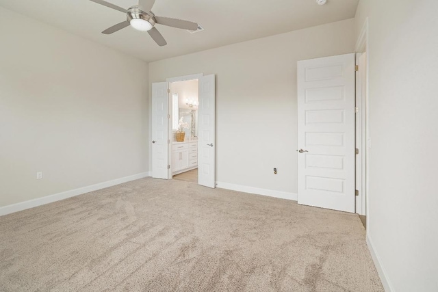 2613 Ibaza Bnd Unit 58, Leander, TX 78641 - unfurnished bedroom featuring light carpet, baseboards, connected bathroom, and ceiling fan