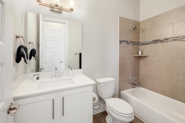 2613 Ibaza Bnd Unit 58, Leander, TX 78641 - bathroom with vanity, toilet, bathing tub / shower combination, and wood finished floors