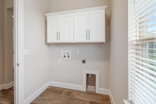 2613 Ibaza Bnd Unit 58, Leander, TX 78641 - laundry area with electric dryer hookup, hookup for a washing machine, cabinet space, baseboards, and hookup for a gas dryer