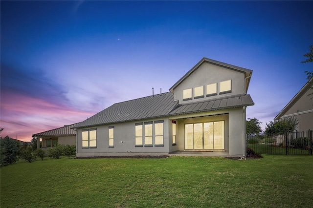 2613 Ibaza Bnd Unit 58, Leander, TX 78641 - back of property at dusk with stucco siding, metal roof, and a standing seam roof