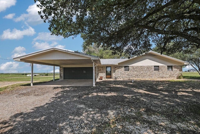 14615 Armstrong Rd, Salado, TX 76571 - view of front of house featuring driveway, a garage, stone siding, metal roof, and an attached carport