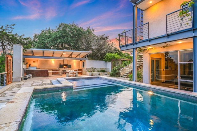 8207 Moon Rise Trl, Jonestown, TX 78645 - pool at dusk with area for grilling, a patio, and stairway