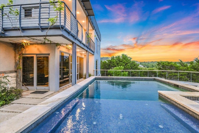8207 Moon Rise Trl, Jonestown, TX 78645 - pool at dusk with an outdoor pool