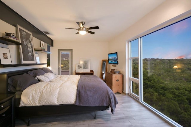 8207 Moon Rise Trl, Jonestown, TX 78645 - bedroom with light wood-type flooring and ceiling fan