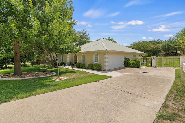606 Explorer, Lakeway, TX 78734 - view of front facade featuring an attached garage, concrete driveway, a gate, and a metal roof