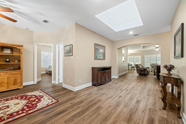 606 Explorer, Lakeway, TX 78734 - living area featuring ceiling fan, arched walkways, wood finished floors, a skylight, and recessed lighting