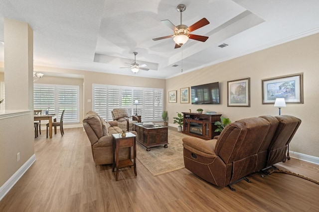 606 Explorer, Lakeway, TX 78734 - living room featuring a raised ceiling, light wood finished floors, and ceiling fan