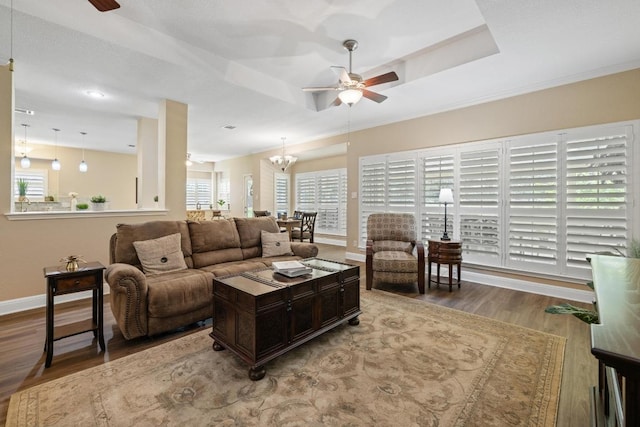 606 Explorer, Lakeway, TX 78734 - living room featuring a ceiling fan, wood finished floors, baseboards, a raised ceiling, and crown molding