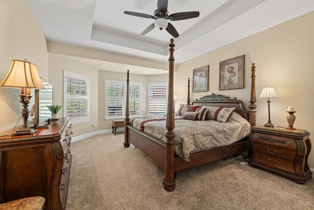 606 Explorer, Lakeway, TX 78734 - bedroom featuring light carpet, a tray ceiling, and a ceiling fan