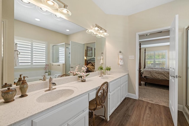 606 Explorer, Lakeway, TX 78734 - ensuite bathroom with wood finished floors, double vanity, a bath, and a shower stall