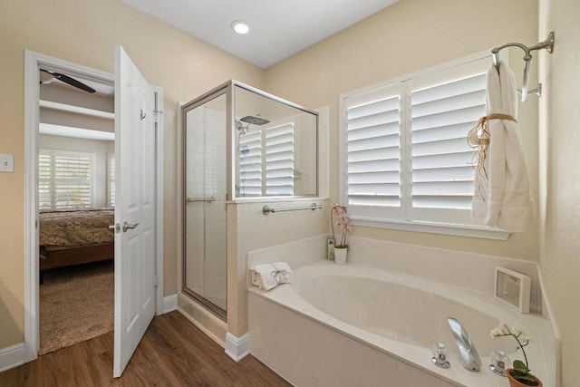 606 Explorer, Lakeway, TX 78734 - full bath featuring a garden tub, a shower stall, wood finished floors, ensuite bathroom, and ceiling fan