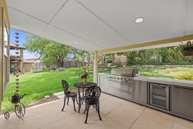 606 Explorer, Lakeway, TX 78734 - fenced backyard with a patio area, beverage cooler, and an outdoor kitchen