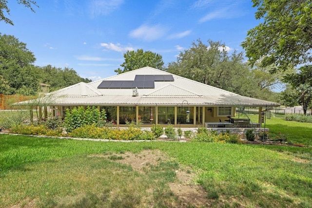 606 Explorer, Lakeway, TX 78734 - back of property with a yard, roof mounted solar panels, a metal roof, and a patio