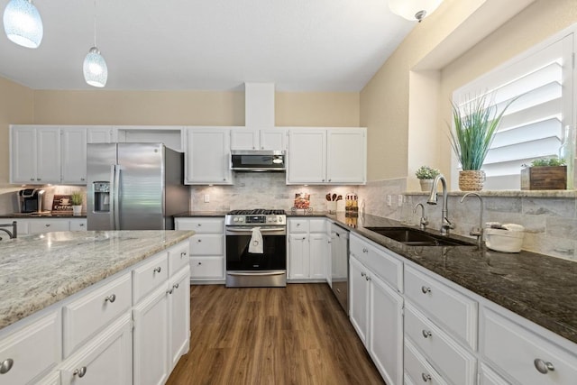 606 Explorer, Lakeway, TX 78734 - kitchen with stainless steel appliances, dark wood-style flooring, dark stone countertops, and white cabinets