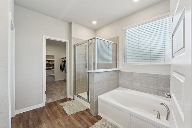 357 Cathedral Mountain Dr, Dripping Springs, TX 78620 - full bath featuring a garden tub, a stall shower, a walk in closet, wood finished floors, and baseboards