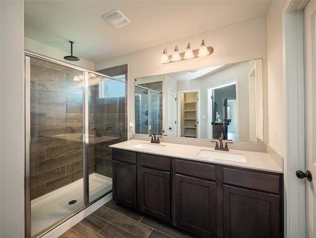 7632 Lombardy Loop, Round Rock, TX 78665 - full bathroom with a stall shower, double vanity, and a spacious closet
